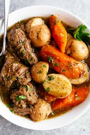 Place roast, one large onion, a few carrots, a package of italian seasoning, 1 can of cream of mushroom soup and garlic into your crockpot. Tender Pot Roast Cafe Delites