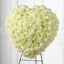 Funeral floral arrangements in london. White Rose Heart Flower Spray At Send Flowers