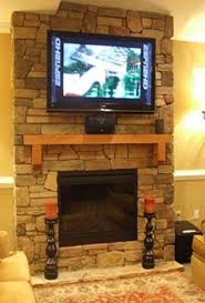 like rock fireplace with tv mounted