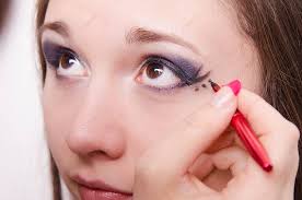 makeup artist paints a model s eyes
