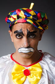 sad clown against a dark background