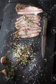 Presentation Of Salted Pork Bacon On Stone Slate