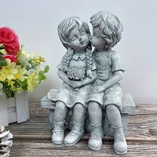 Boy Kissing Girl Statue Sitting On