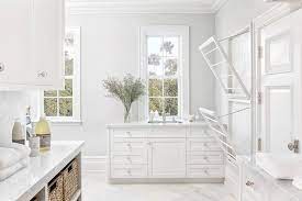 All White Laundry Room With Stacked