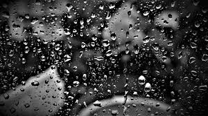 water drops on a window with black