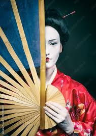 woman in geisha makeup covering half of