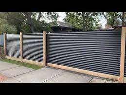 These panels perfectly complement your driveway, garden or backyard. Corrugated Steel Exposed Post Fence With Sleeper Automatic Sliding Gate Youtube Metal Fence Panels Backyard Fences Privacy Fence Designs