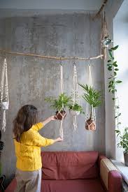 Woman Holding Macrame Plant Hanger With