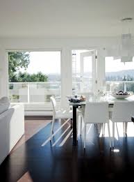 The dining table is made of wood and is paired with white chairs. White Living Room Furniture With Dark Wood Floors Interior Design Ideas Ofdesign