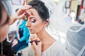 makeup artist or beautician doing