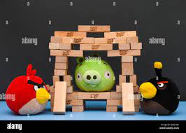 Bomb and Red Angry Birds standing beside of Bad Piggy sitting inside of  castle, made from Jenga bricks Stock Photo - Alamy