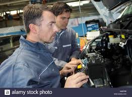 Car Mechanic And Assistant In Garage Stock Photo 278149715