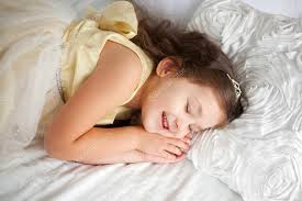 girl sleeping and smiling in her sleep