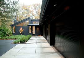 The walls, the trim, and the accent. On Trend Bold And Black Exterior House Color
