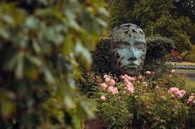 A Stone Head With A Face In The Garden