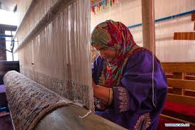 people work at carpet weaving work