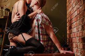 Dominatrix Woman Kissing Her Partner, Sitting On Table Stock Photo, Picture  and Royalty Free Image. Image 75718060.
