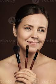 middle aged woman with a makeup brushes