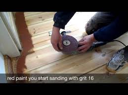 sanding floorboards with the edge