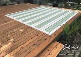 outdoor area rug on a wood deck