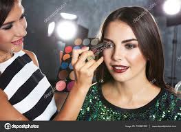 makeup artist and woman stock photo by