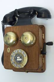 a wooden wall phone with bakelite horn