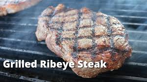 grilled ribeye steaks on weber kettle