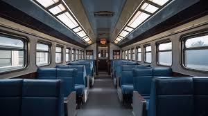 this train car is full of blue seats