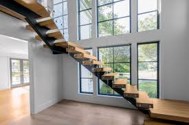 This contemporary foyer features a staircase with black metal railing and silver cable supports. Glass Staircase Home Remodel Riverside Ct Keuka Studios