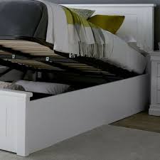 white wooden ottoman storage bed