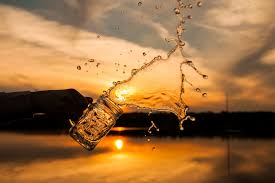 water being splashed out of a mason jar