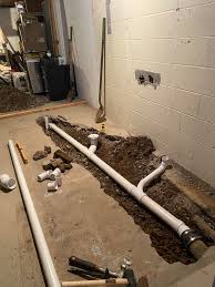 Drill holes, cut pipes, and connect them in a dry run using drain fittings. Basement Bathroom Renovation Plumbing