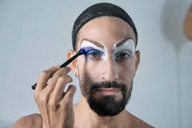 mid man applying blue eyeshadow
