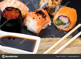 Sushi Pieces On Slate Presentation Table Stock Photo