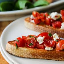 Spread each slice with 1 tablespoon of goat cheese and top with 1 tablespoon of tomato and 1 teaspoon of onion. Tomato Basil And Feta Bruschetta Something New For Dinner