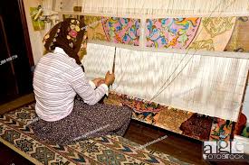 handicraft woman making a carpet