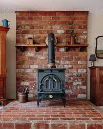 Old Wood Stove On Brick Hearth By
