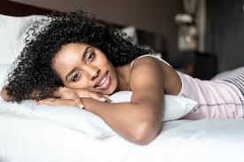 Black Woman Happy On Bed Smiling