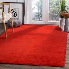 red rug and wall to wall carpeting