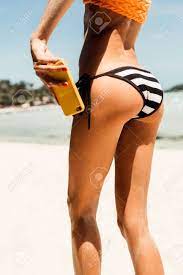 Skinny Young Beautiful Woman Taking A Selfie Self Portrait Of Her Ass In A  Black And White Bikini At The Camera On Her Smartphone Digital Camera.  Outdoor Lifestyle Picture On A Hot