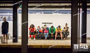 subway riders wait for a train at the