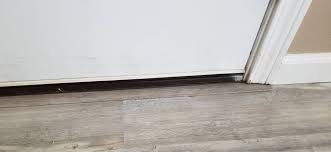 Look at the warranty, core construction, wear level, and attached underlayment before making a final decision. Vinyl Plank Flooring Entry Way Door Trim Question Home Improvement Stack Exchange