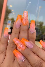 What another way to create nails radiating energy and happiness other than a color that came as a combination refresh your mood with rays of sunshine on your nails with any orange shades. Neon Orange Orange Coffin Nails With Glitter Nail And Manicure Trends