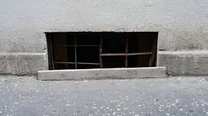 A Barred Window In The Basement In The