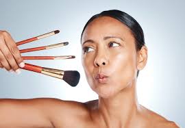 senior woman with makeup brushes