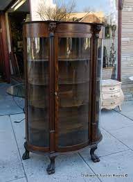 antique curio cabinet with curved glass