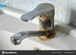 Old, rusty faucet in the kitchen, limestone, scum, need a replacement.  Stock Photo by ?gadzik.oleg@gmail.com 323943148