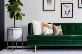 emerald green velvet tufted sofa on