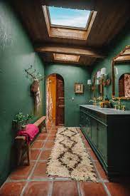 A Dark Green Bathroom With Unexpected