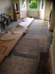 bad quality wooden floor under carpet